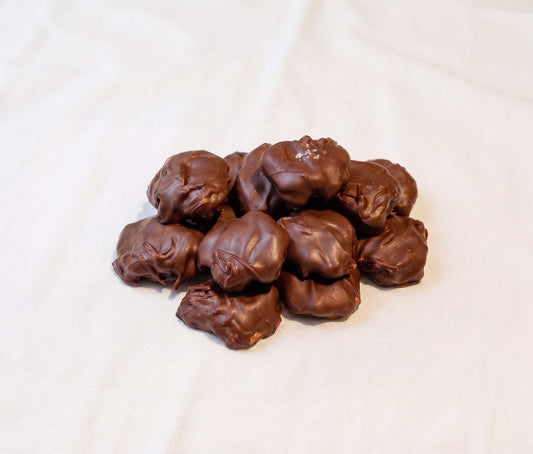 handcrafted caramel pecan clusters coated in dark chocolate